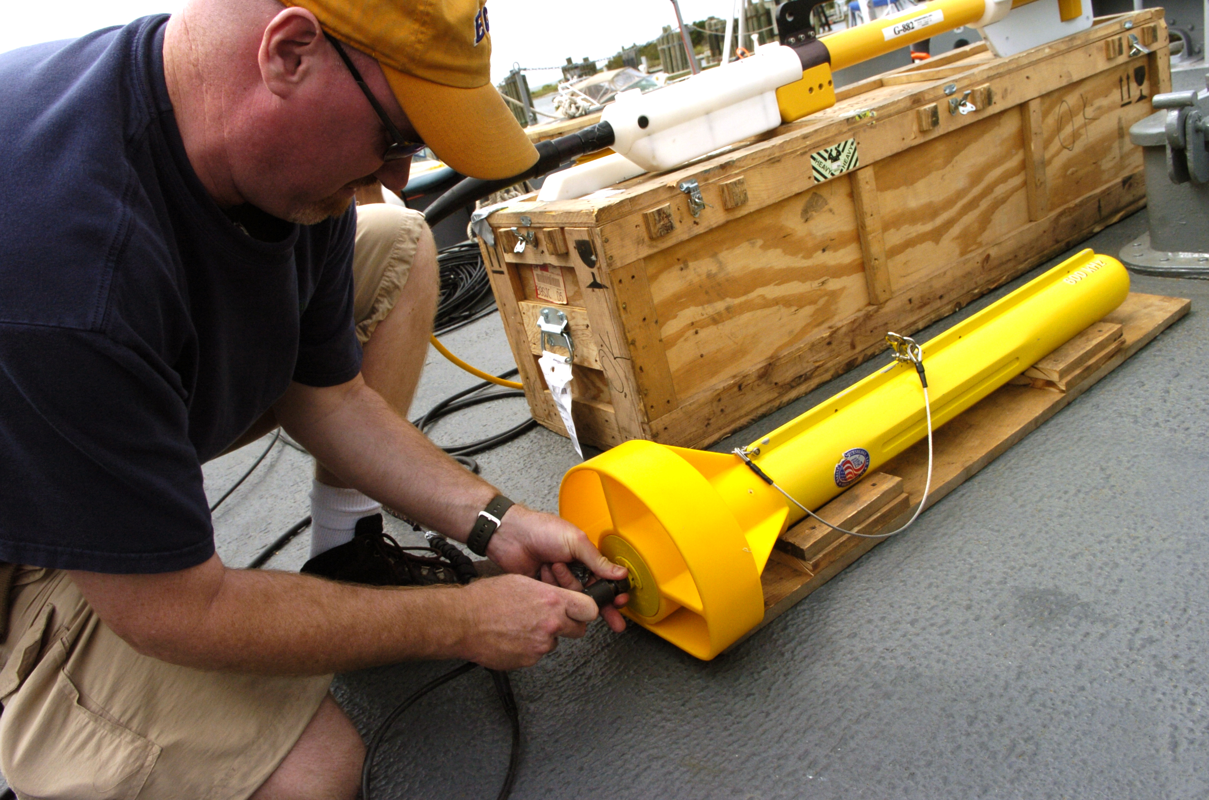 Marine sonar towfish being prepared on a vessel deck